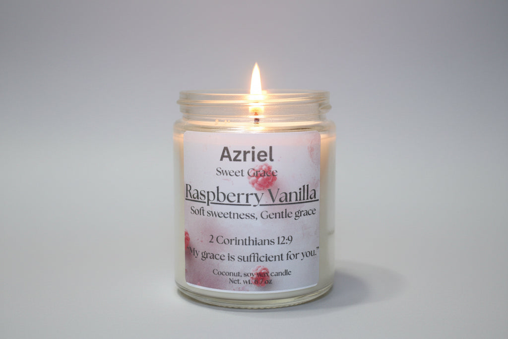 Candle in a glass jar with a label reading 'Azriel Raspberry Vanilla' on a neutral background.