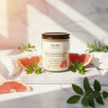 Candle jar labeled 'Azriel Pink Grapefruit Glow' on a beige background