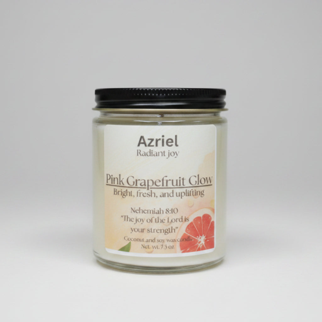 Candle jar labeled 'Azriel Radiant Joy Pink Grapefruit Glow' on a wooden surface