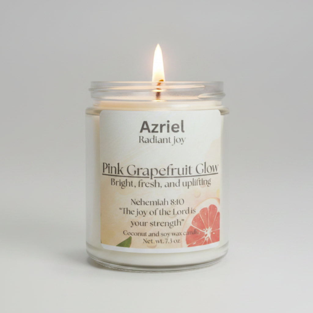Candle in a glass jar labeled 'Azriel Pink Grapefruit Glow' on a neutral background