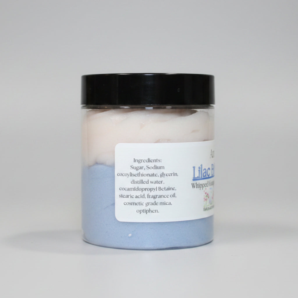Jar of whipped body butter with a label on a brown background