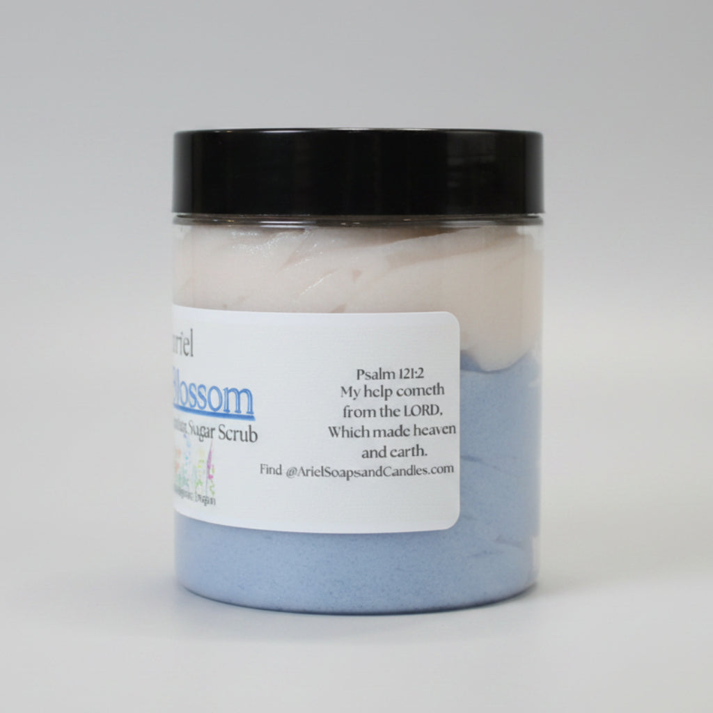 Jar of sugar scrub with a black lid on a brown surface