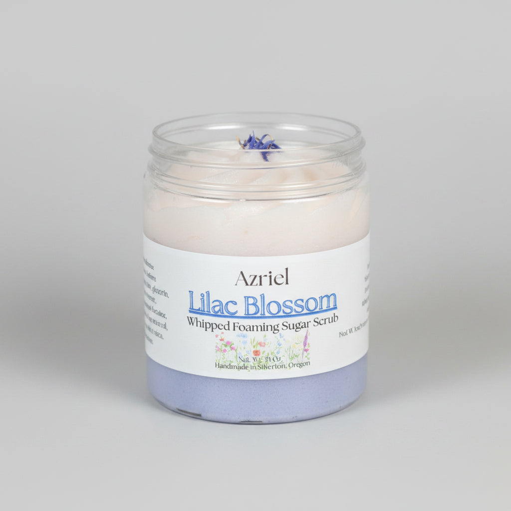 Jar of Azriel Lilac Blossom Whipped Foaming Sugar Scrub on a brown background