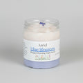 Jar of Azriel Lilac Blossom Whipped Foaming Sugar Scrub on a brown background