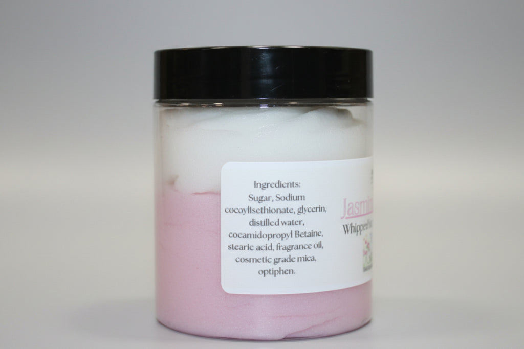 Jar of pink bath product with black lid on a beige background
