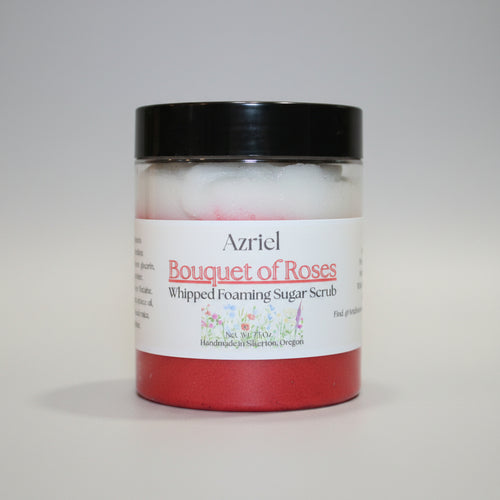 Jar of 'Bouquet of Roses' whipped foaming sugar scrub with a black lid on a beige background