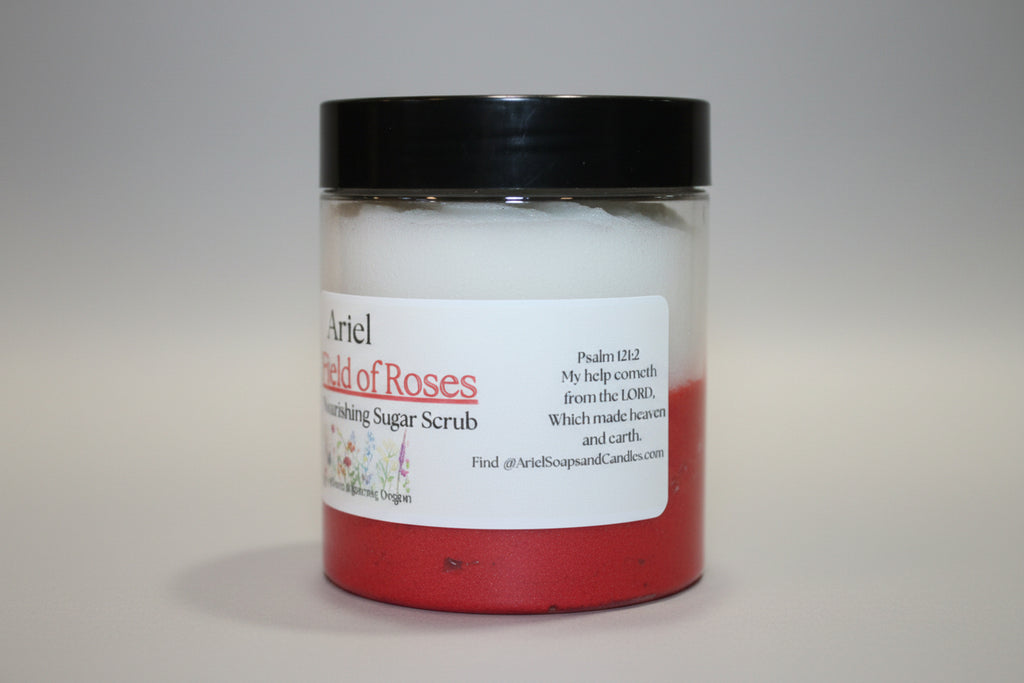 Jar of Airelle's Roses body scrub with a black lid on a beige surface.