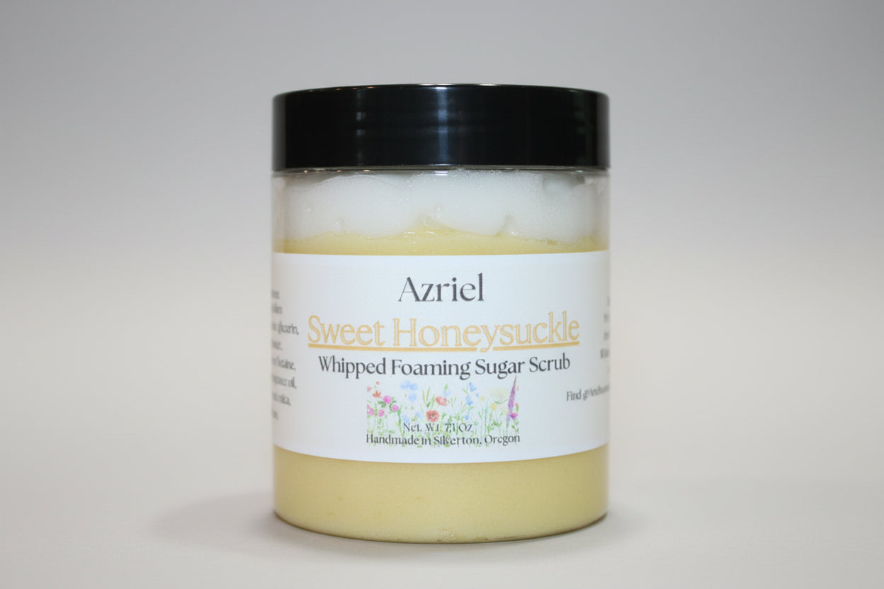 Jar of Azriel Sweet Honeysuckle whipped foaming sugar scrub with a black lid on a beige background