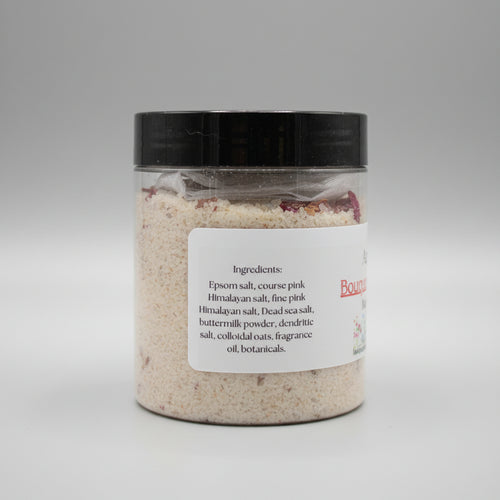Jar of bath salts with a label on a beige surface