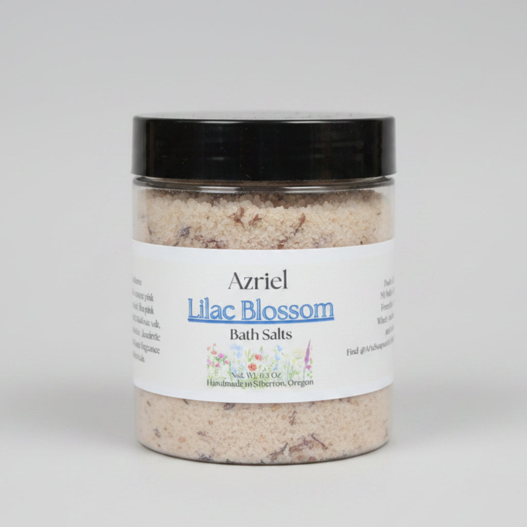 Jar of Azriel Lilac Blossom Bath Salts on a beige surface with a neutral background