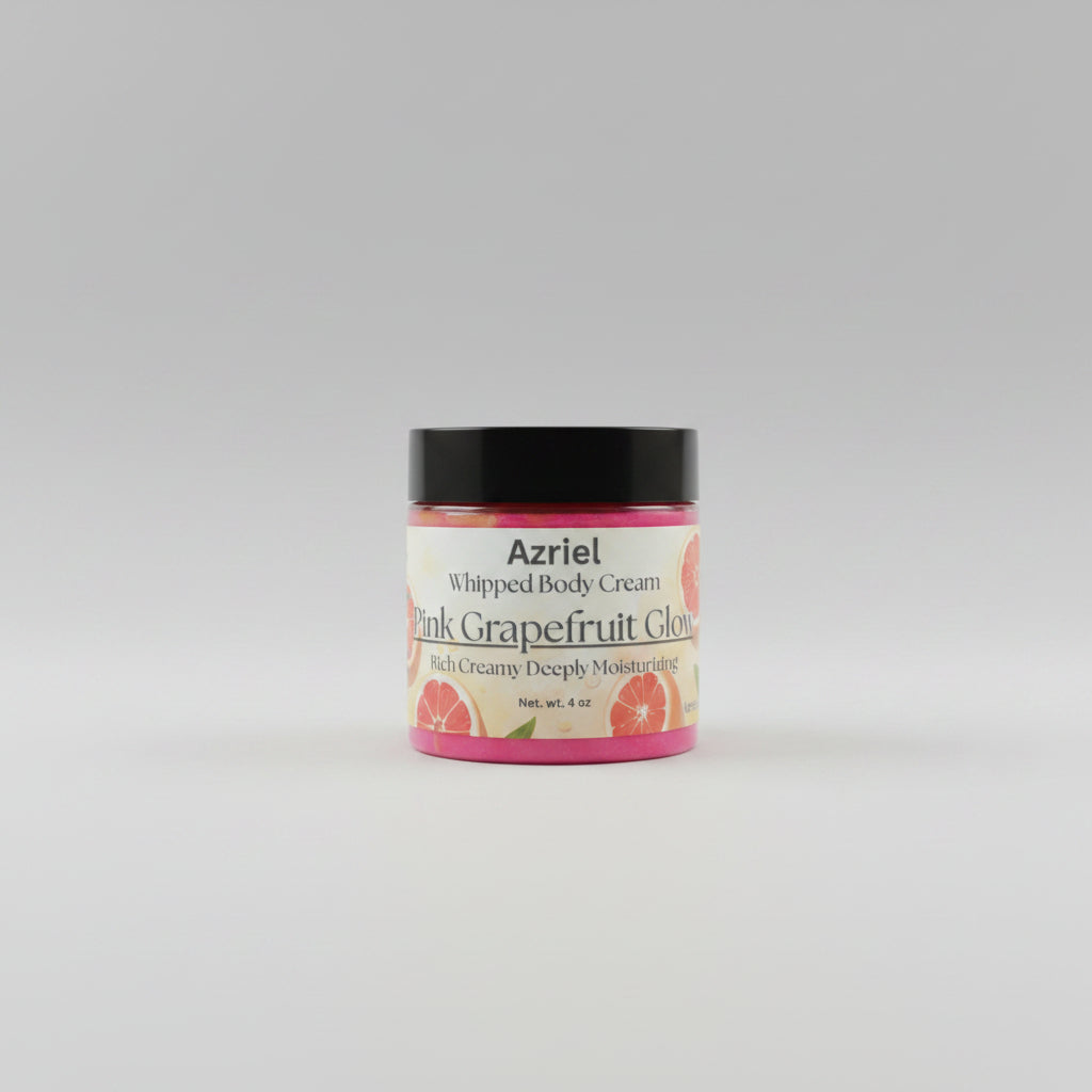 Jar of Azriel Pink Grapefruit Glow Whipped Body Cream on a beige background