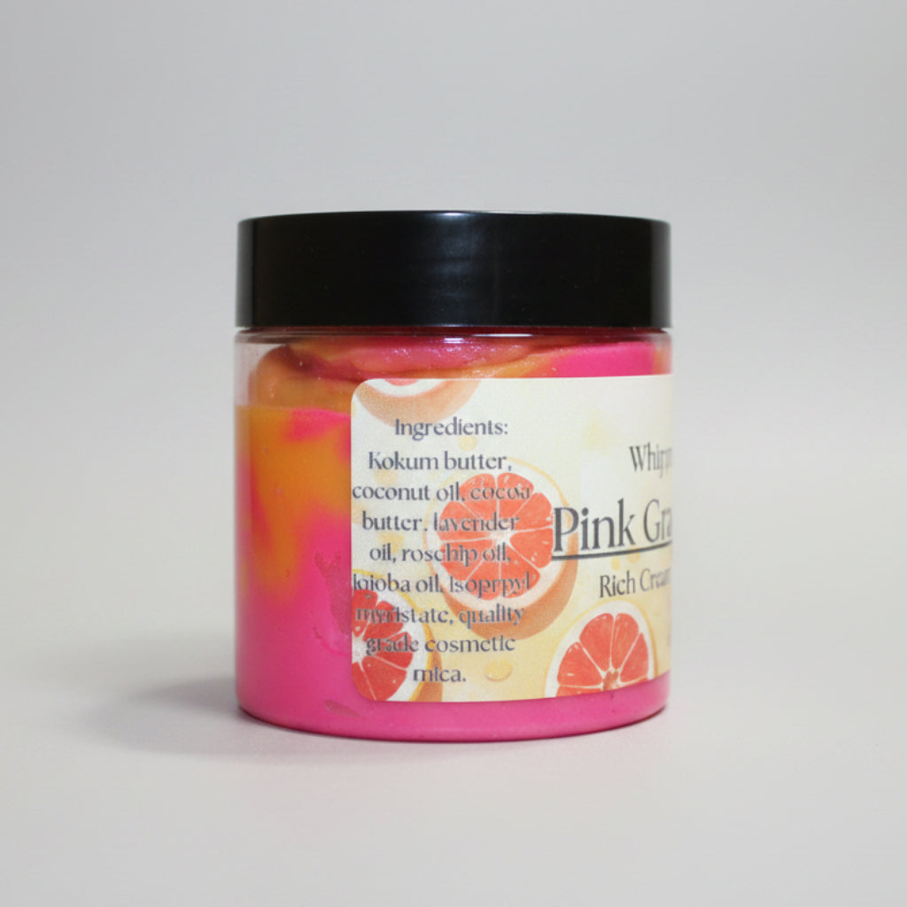 Jar of pink body butter with a black lid on a beige background