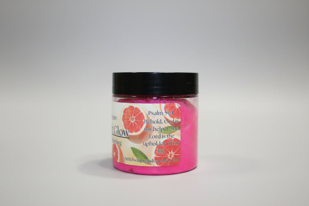 Pink candle with a black lid on a beige surface