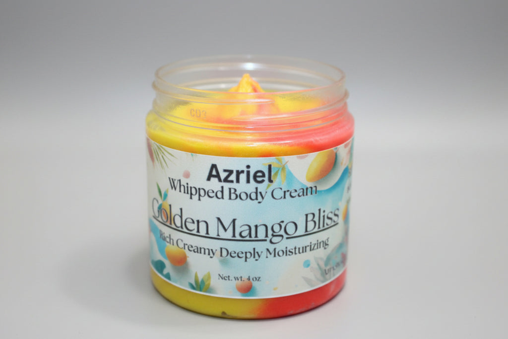 Jar of Azriel Whipped Body Cream in Golden Mango Bliss on a brown background