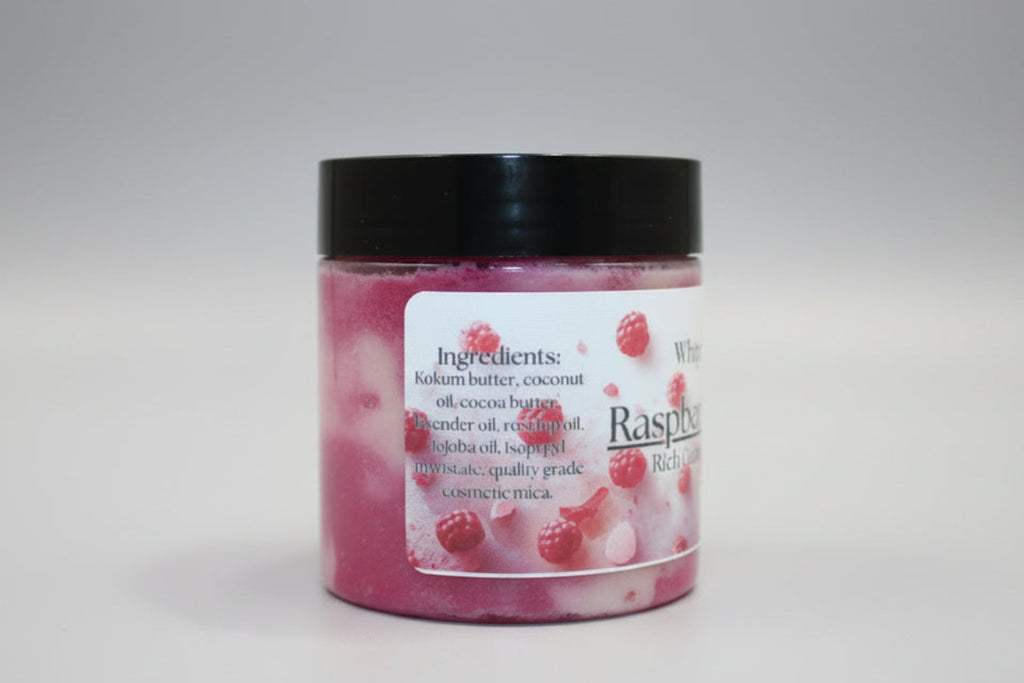 Jar of raspberry-flavored product with a black lid on a beige surface.