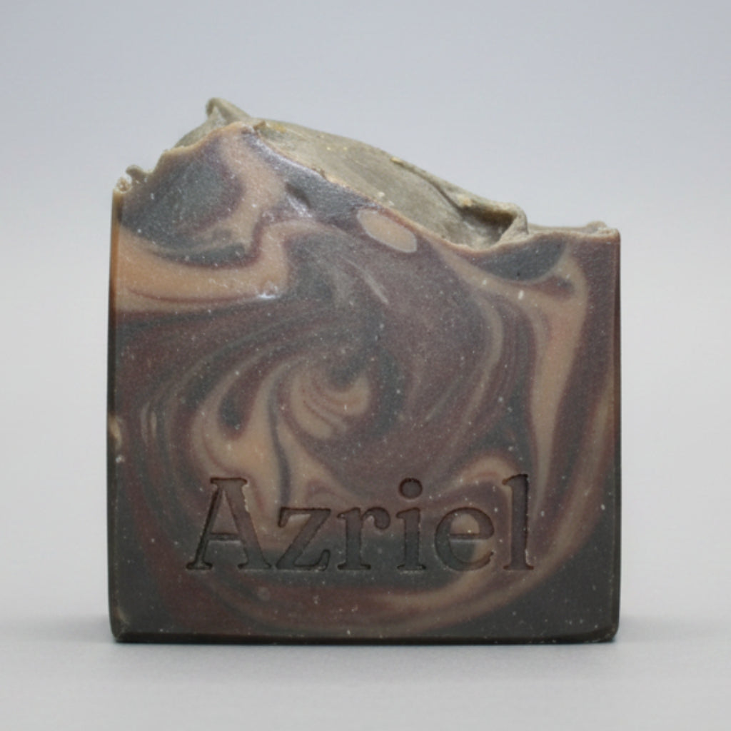 Bar of soap with 'Azriel' branding on a cardboard background