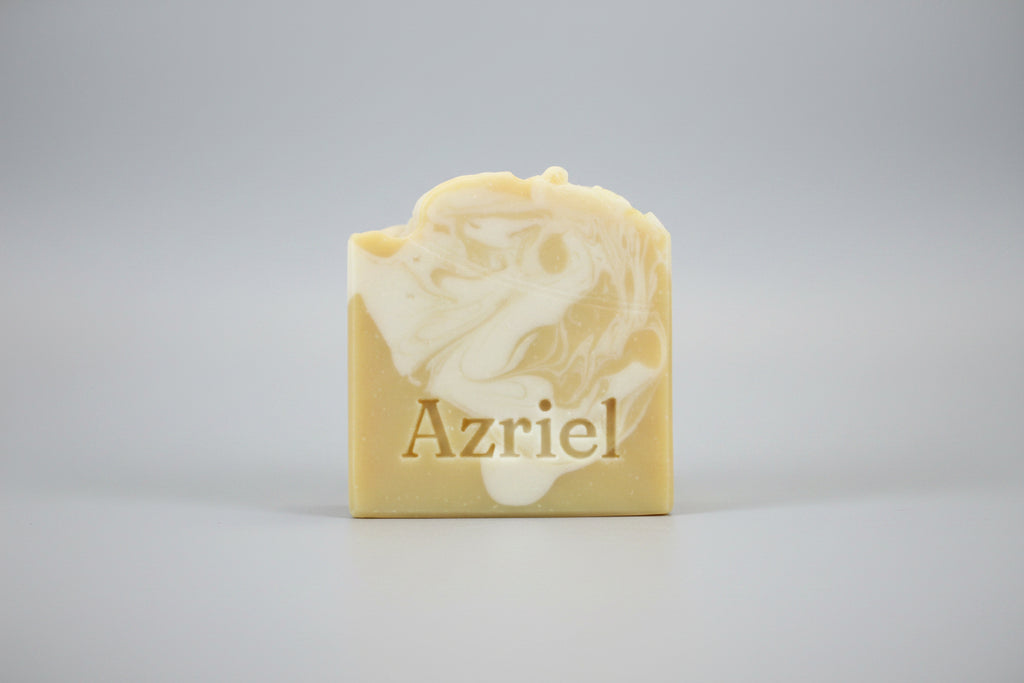 Bar of soap with a floral design on a brown surface