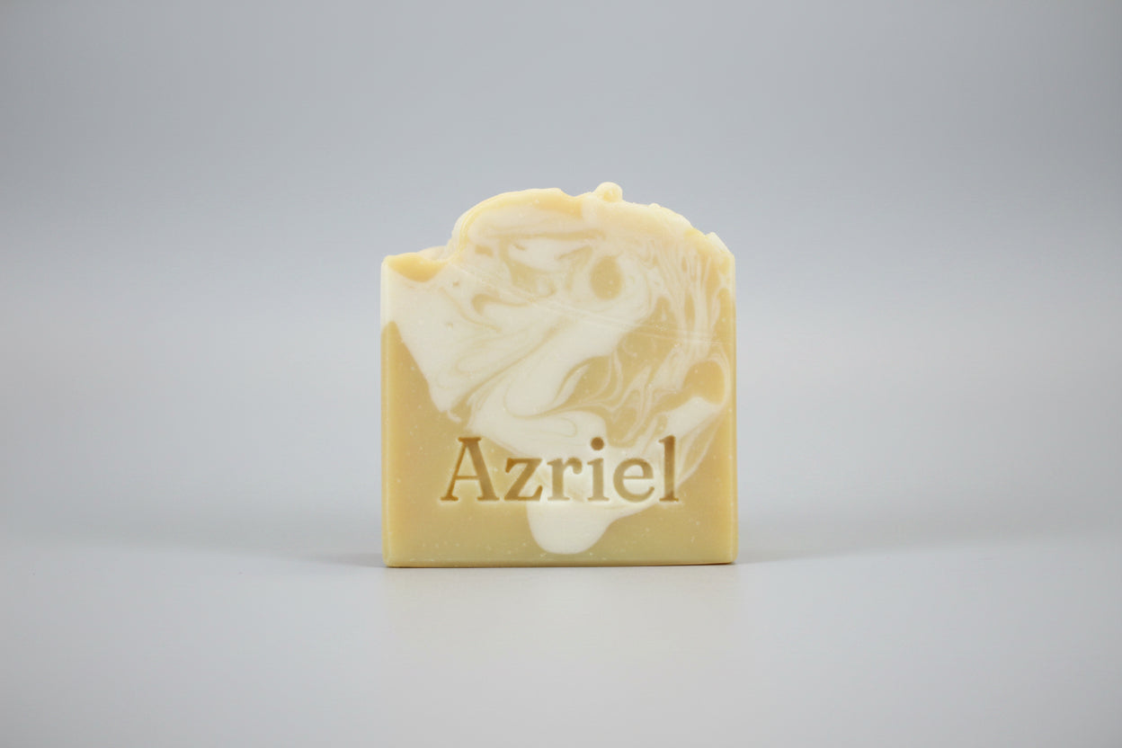 Bar of soap with a floral design on a brown surface
