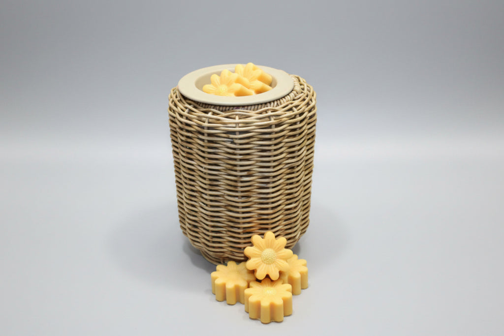 Wicker basket with yellow flower-shaped objects on a tiled bathroom floor.