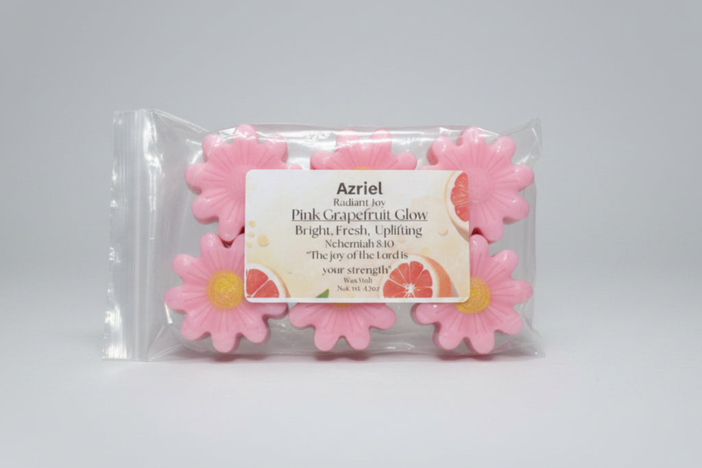 Pink grapefruit-scented wax melts in packaging with a label on a cardboard background