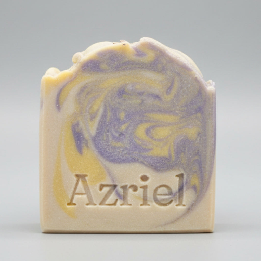 Bar of soap with blue and yellow swirls and 'Azriel' branding on a brown background
