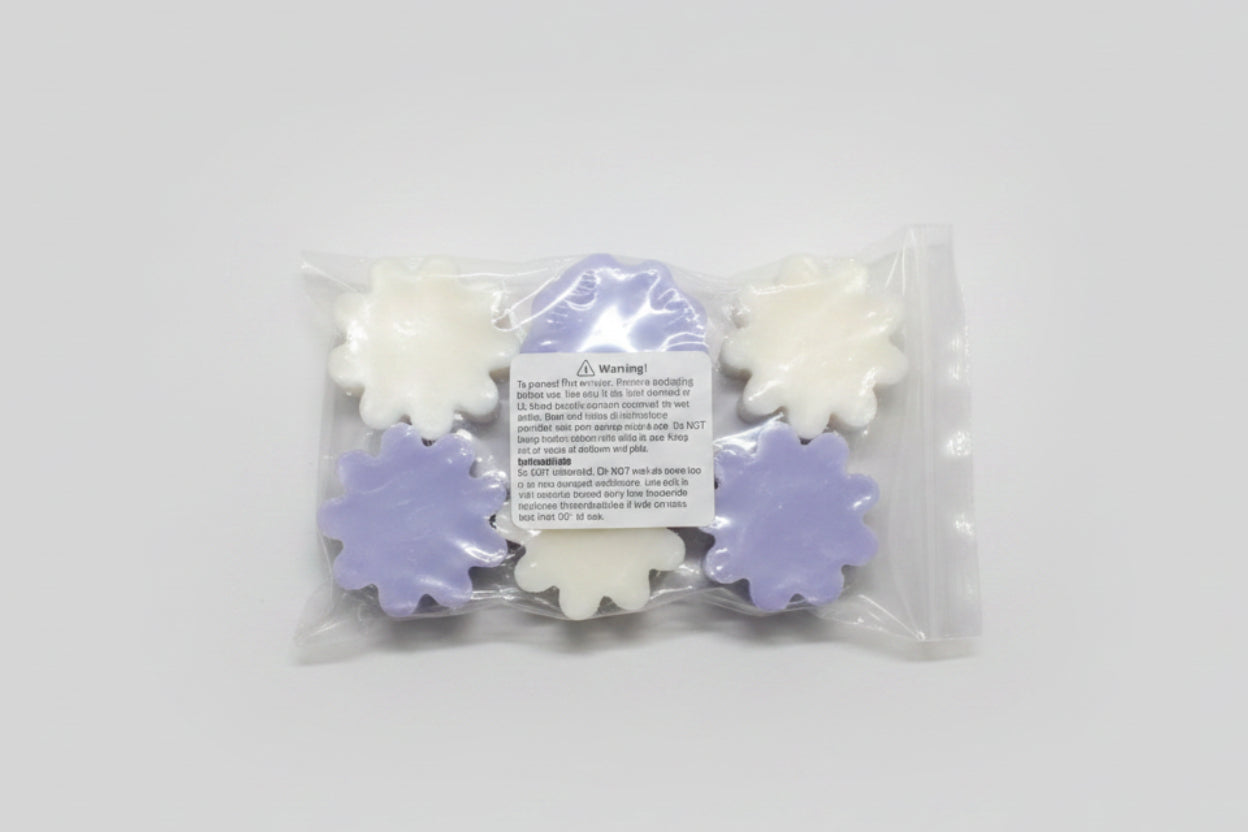 Packaged flower-shaped wax melts with a warning label on a brown background