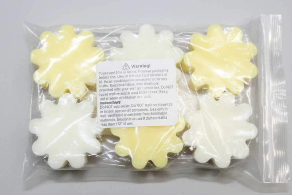 Packaged yellow and white wax melts with a warning label on a cardboard background