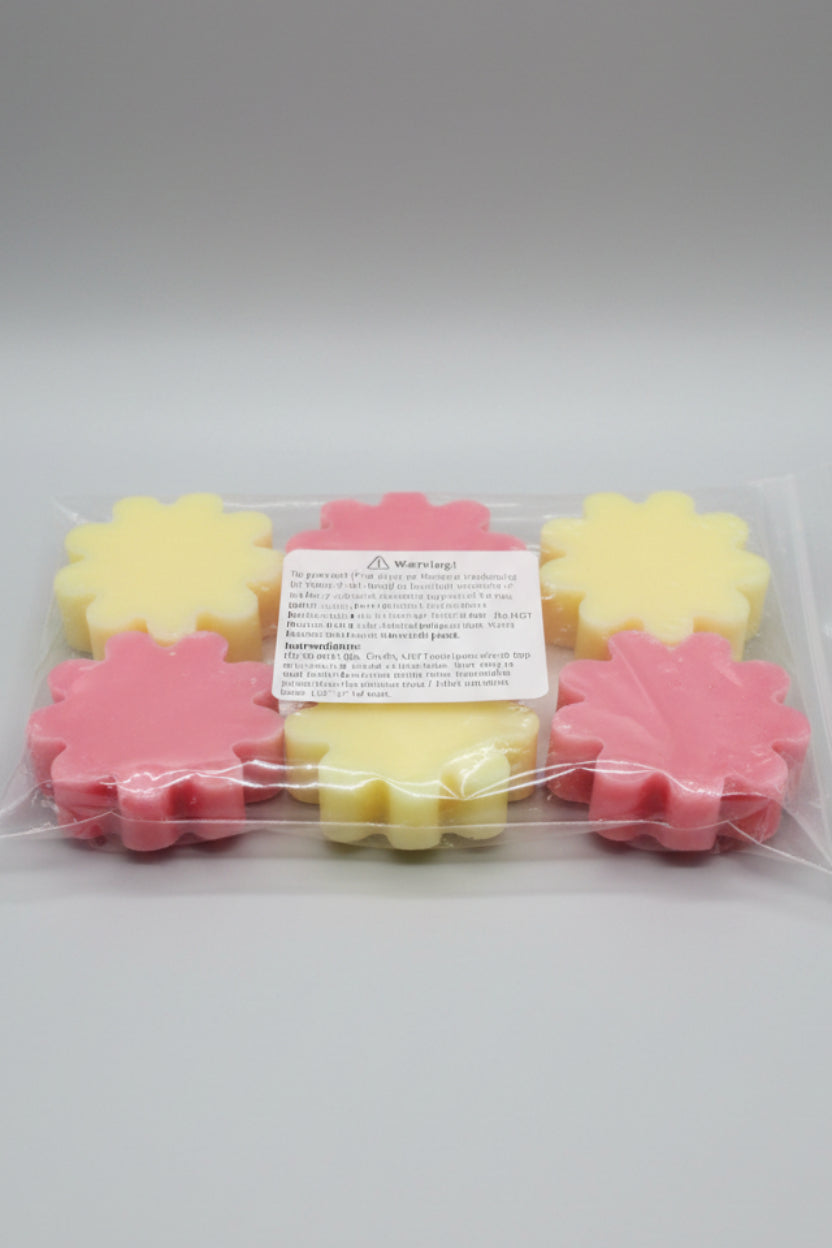 Packaged pink and yellow leaf-shaped candies on a cardboard background