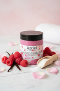 Jar of Azriel Raspberry Vanilla Bliss sugar scrub on a beige surface
