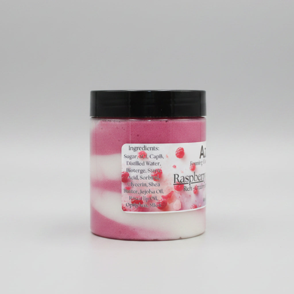 Jar of raspberry-flavored product with a black lid on a beige surface.
