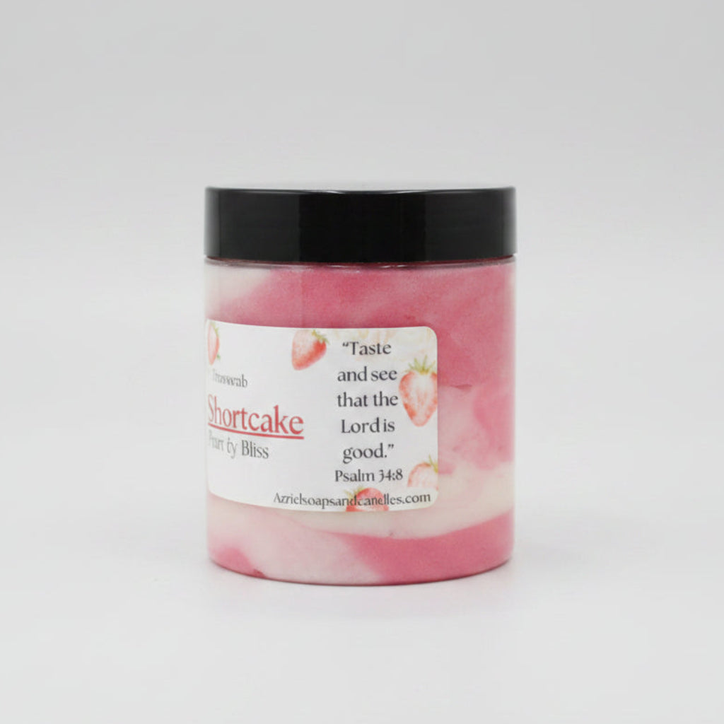 Pink and white candle jar with black lid on a beige surface