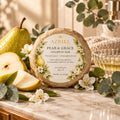 A round soap bar wrapped in brown kraft paper, featuring a white circular label for Azriel Pear & Grace Shampoo Bar with illustrations of pears and leaves.