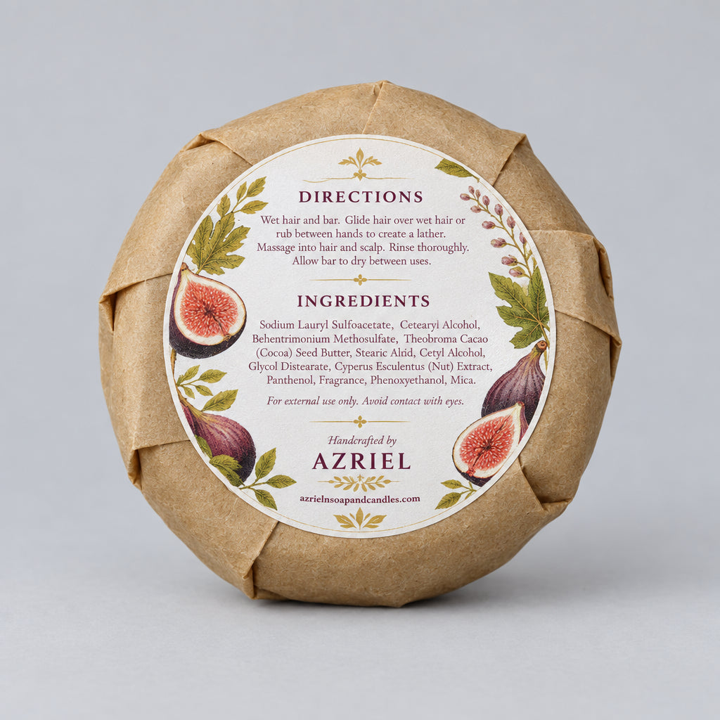 A round wrapped soap or bar product in brown kraft paper with a large white circular label featuring fig illustrations and the brand name Azriel. The label includes directions and ingredients text, photographed on a wooden surface.